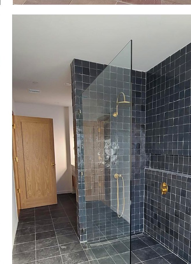 Zellige-tiled shower with brass fixtures