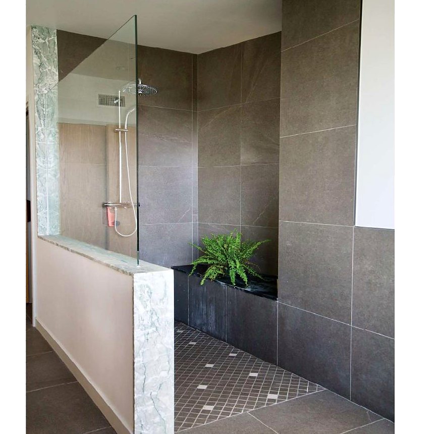 Stone-tiled shower with planter detail